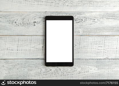 black electronic tablet on vintage shabby white wooden background. the view from the top. flat lay