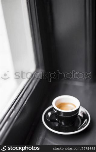 black empty coffee cup with coffee stains window sill