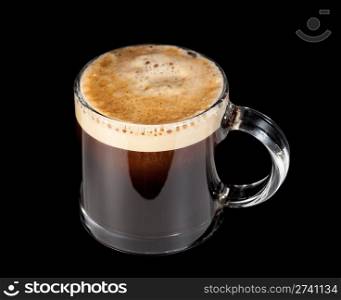Black expresso coffee with heady froth in a glass mug or cup with path around the edge