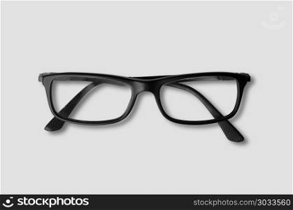 Black eye glasses isolated on grey background. Black glasses isolated on grey. Black glasses isolated on grey