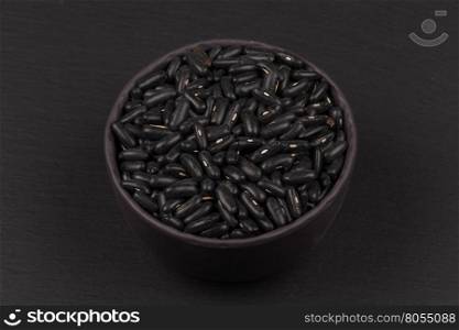 Black eyed peas beans in a bowl on a dark background