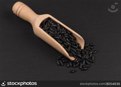 Black eyed peas beans in scoop on a dark background