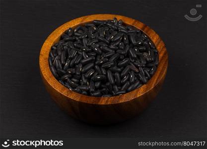 Black eyed peas beans in wooden bowl on a dark background
