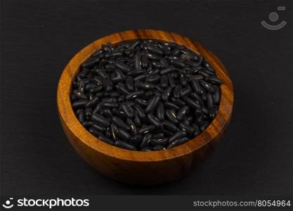 Black eyed peas beans in wooden bowl on a dark background