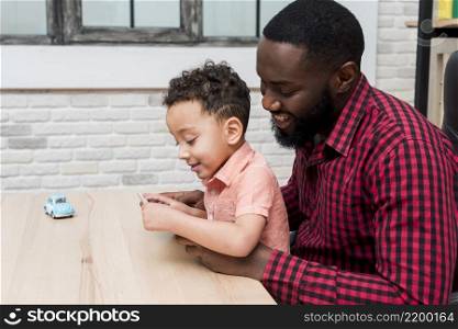 black father son using tablet