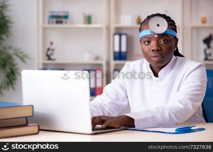 Black female doctor working at clinic 