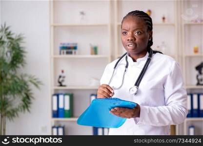 Black female doctor working at clinic 