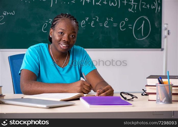 Black female student in front of chalkboard