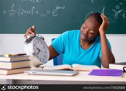 Black female student in front of chalkboard  