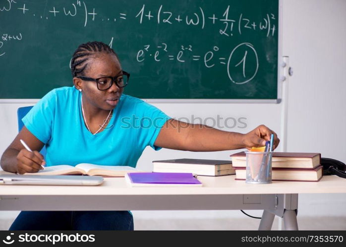 Black female student in front of chalkboard  