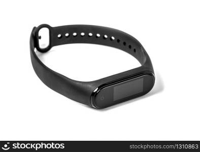 Black fitness watch (activity tracker) on white. Closeup, selective focus