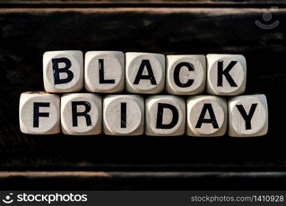 Black friday concept with wooden block on wooden table background