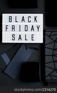 Black Friday online sale concept. Monochromatic flatlay on a dark background. Smartphone and accessories.. Black Friday online sale concept. Monochromatic flatlay on dark background. Smartphone and accessories.
