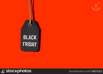 Black friday tag isolated on red background with copy space