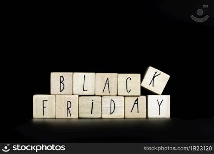 Black Friday text written with wooden cubes on black background horizontal, simplicity modern background texture copy space. Black Friday text written with wooden cubes on black background horizontal, simplicity modern background texture