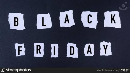 Black Friday words text into white paper torn on black background