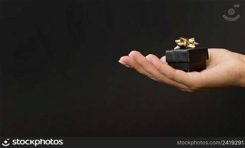black gift box with golden ribbons