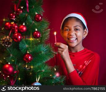 black girl dressed as Santa Claus who decorate the Christmas tree with lights, balls and candles