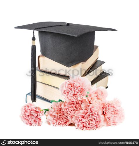 Black graduate (academic) hat on the stack of big books and a bouquet of pink carnation flowers, isolated on white background