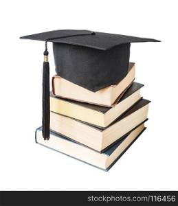 Black graduate (academic) hat on the stack of big books, isolated on white background