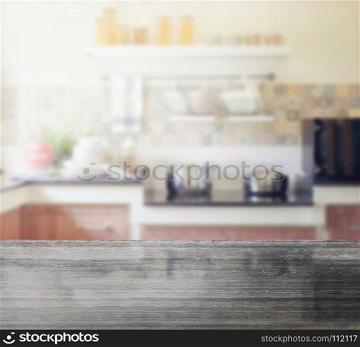 black granite table top and blur of modern kitchen interior as background