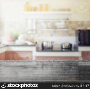 black granite table top and blur of modern kitchen interior as background