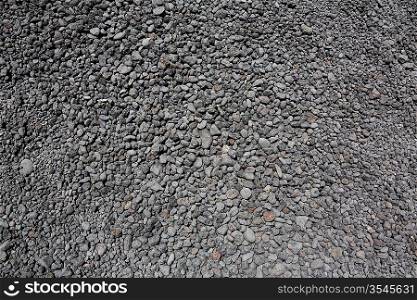 black gray volcanic lava rolling stones texture in Lanzarote