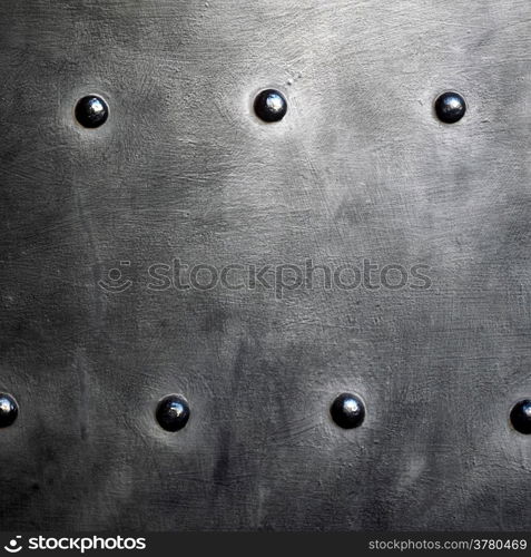 Black grunge metal plate or armour texture with rivets as background
