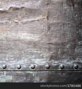 Black grunge metal plate or armour texture with rivets as background