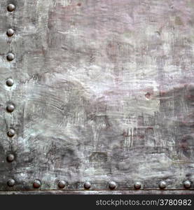 Black grunge metal plate or armour texture with rivets as background