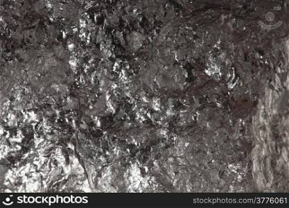 Black hard bituminous coal, carbon nugget closeup macro texture background. Power and energy source.