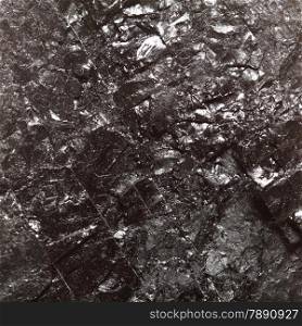 Black hard bituminous coal, carbon nugget closeup macro texture background. Power and energy source.