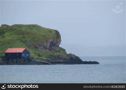 Black house with red roof