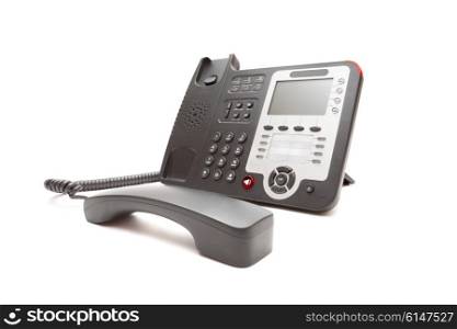 Black IP office phone isolated on white background closeup