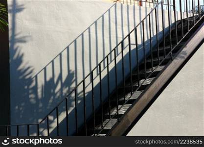 black iron stairs on cement wall