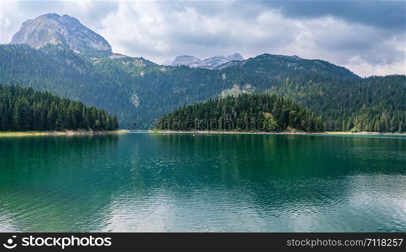 Black lake (Crno jezero) summer cloudy landscape. Zabljak Municipality, Montenegro.