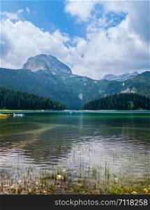 Black lake (Crno jezero) summer landscape. Durmitor, Zabljak Municipality, Montenegro. People are unrecognizable.