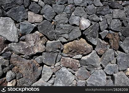 Black lava stone volcanic masonry wall in Canary Islands