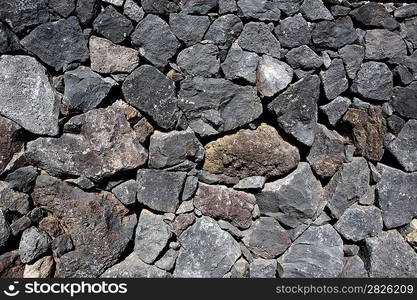 Black lava stone volcanic masonry wall in Canary Islands