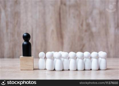 black leader businessman with crowd of wooden employees. leadership, business, team, teamwork and Human resource management concept