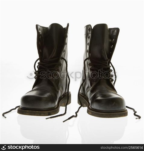 Black leather high top boots with untied laces.