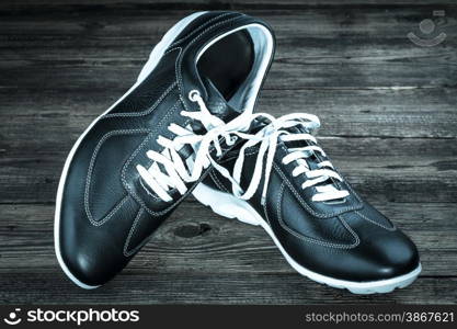 black leather man&rsquo;s shoe on wooden background