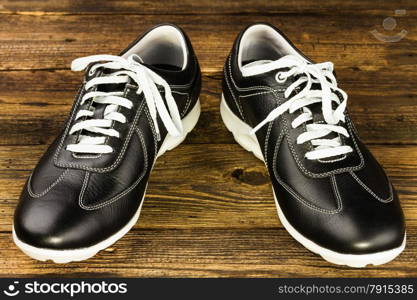 black leather man&rsquo;s shoe on wooden background