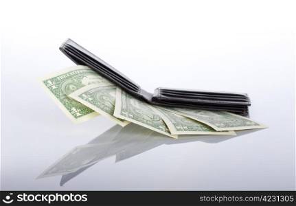 black leather purse with one dollar banknotes inside