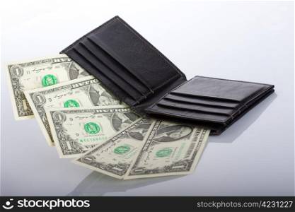 black leather wallet with dollar banknotes inside