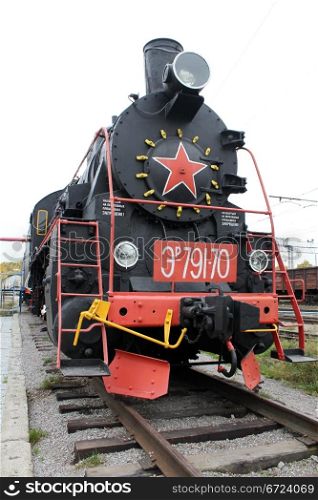 Black locomotive on the railway station in Medvezshyegorsk, Karelia, Russia