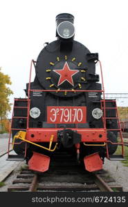 Black locomotive on the railway station in Medvezshyegorsk, Karelia, Russia