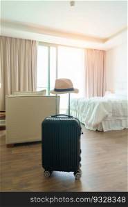 Black Luggage with hat in modern hotel room after door opening. Baggage for Time to travel, service, journey, trip, summer holiday and vacation concepts