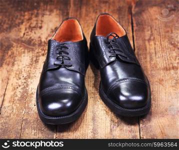 black man&rsquo;s shoes on wooden background