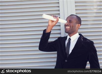 black man searching thru paper spyglass